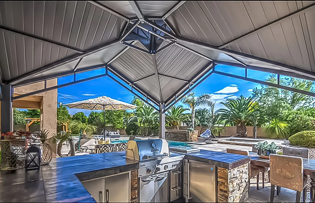 Covered outdoor kitchen addition with poolside dining